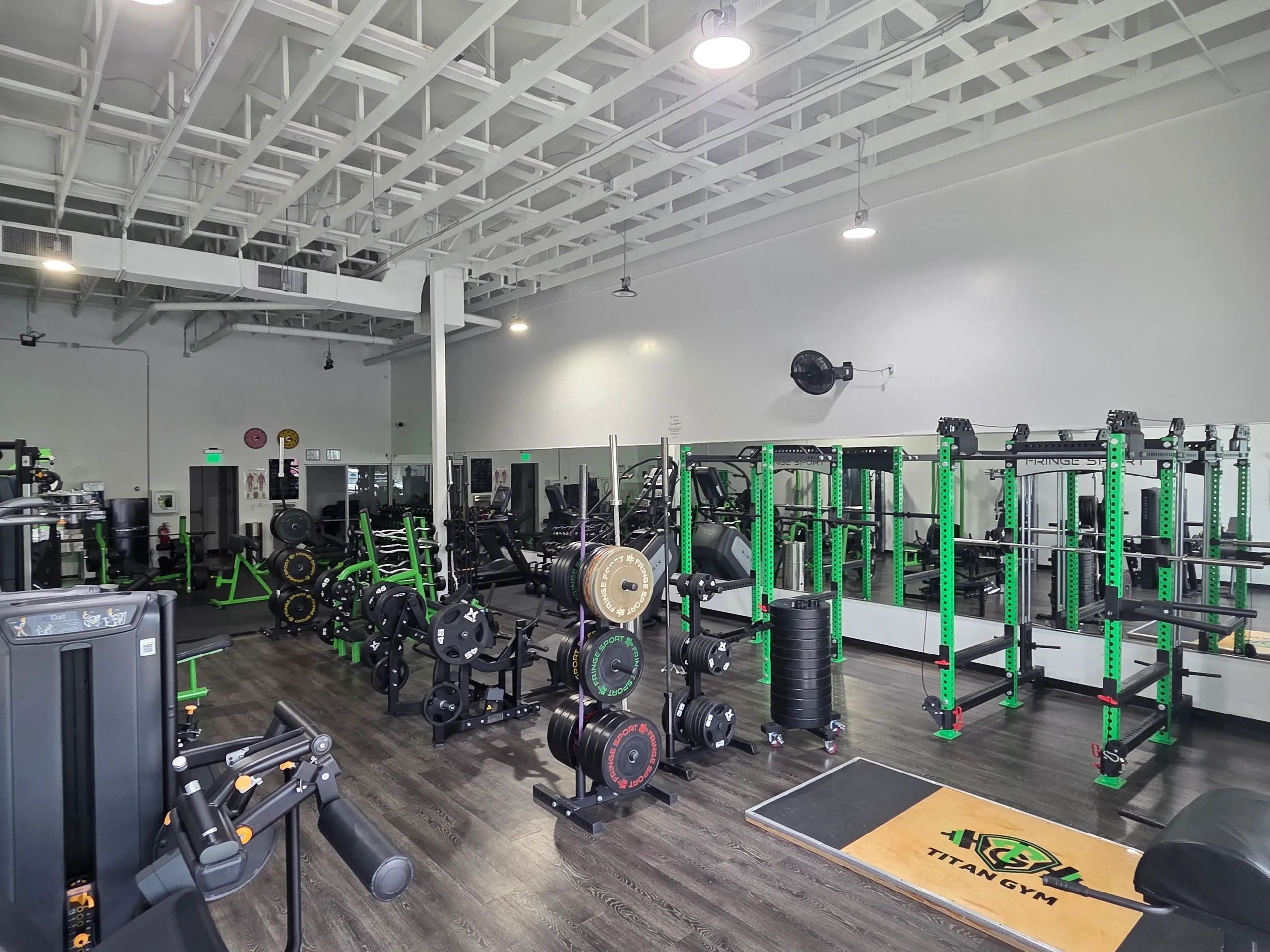 Spacious gym floor with weight racks