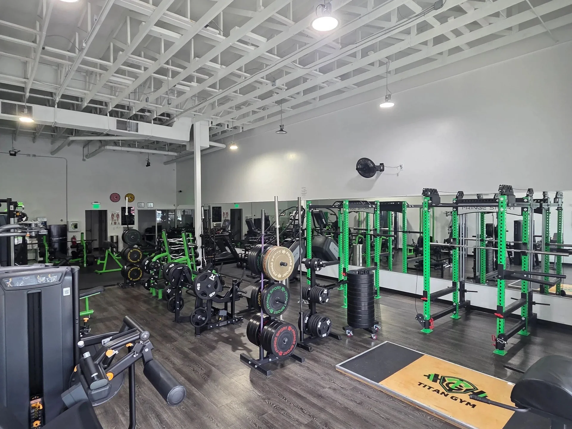 Titan Gym training floor with green power racks and strength equipment